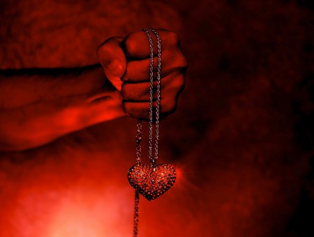 Person Holding Heart Pendant Necklace Wallpaper