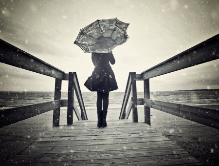 Person Standing Holding Umbrella On Bridge Grayscale Photography
