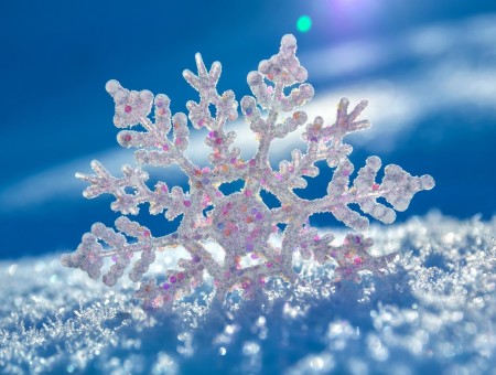 Closeup Of A Snowflake Standing Up In A Pile Of Snow