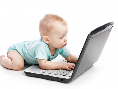 Baby In Blue Onesie Using Laptop