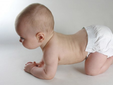 Baby In White Diaper Crawling