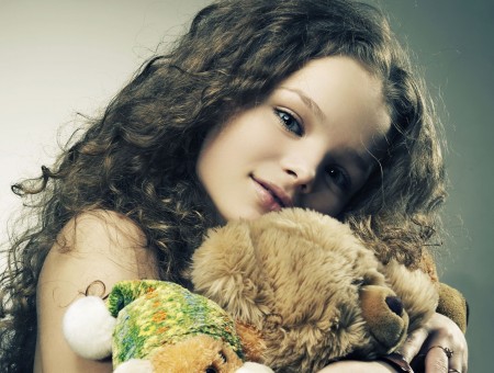 Girl Hugging A Brown Teddy Bear