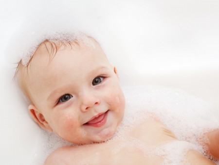 Infant Taking A Bath While Smiling