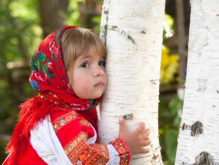 Girl In Red Hugging A Trunk