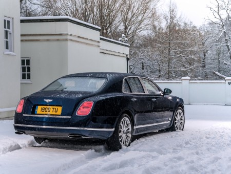 Black Bentley Sedan On Snow During Daytime
