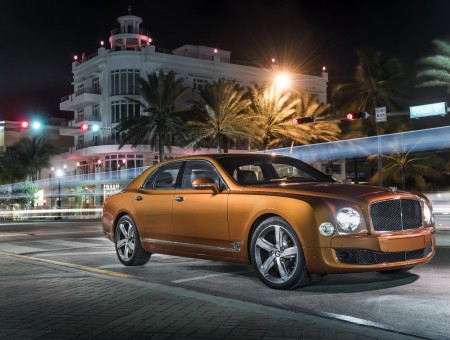Brown Bentley Continental On The Road During Nighttime