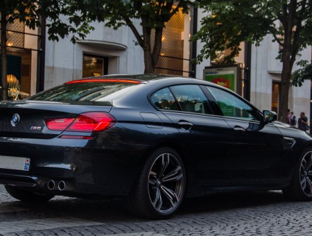 Black BMW M6 Sedan In Front Of A Building