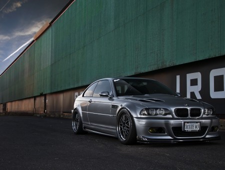 Silver BMW M3 Coupe Car Parked Beside Warehouse
