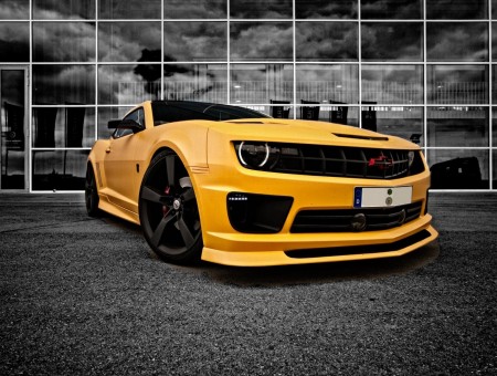 Yellow Chevrolet Camaro Before Glass Wall Building