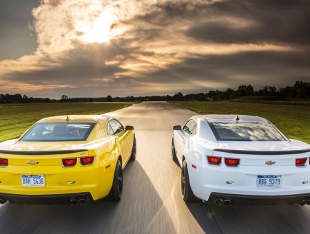 Two Yellow And White Sports Car On Highway At Daytime