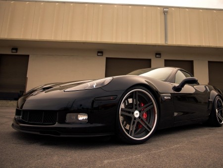 Black Sports Coupe Parked On Black Cement Ground
