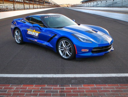 Blue And Black Coupe Sports Car On Gray Race Track