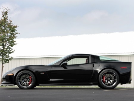 Black Corvette Sports Car On Gray Concrete Pavement