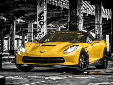 Yellow Corvette Stingray Parked Beside Concrete Post In Selective Color Photography