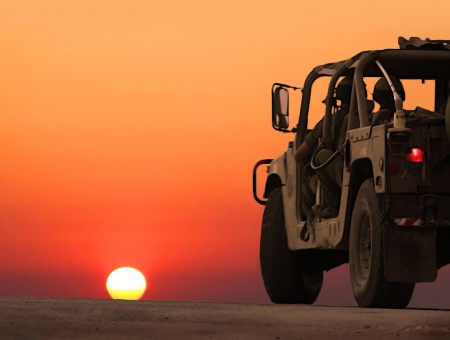 2 Military Men Riding Humvee During Sunset