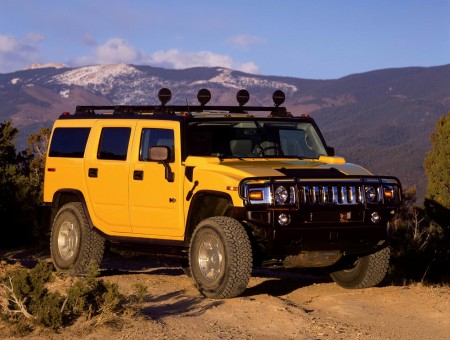 Yellow Hummer H2 On Brown Dirt During Day Time
