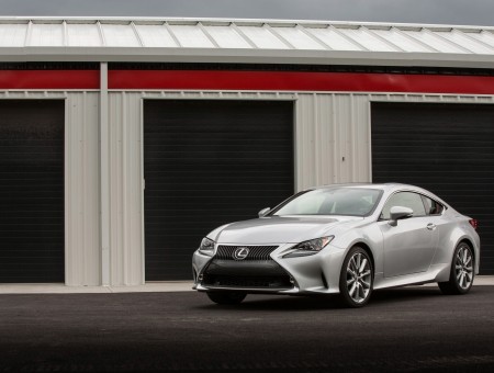 Gray And Black Lexus Sports Coupe Beside A Close Roll Up Door