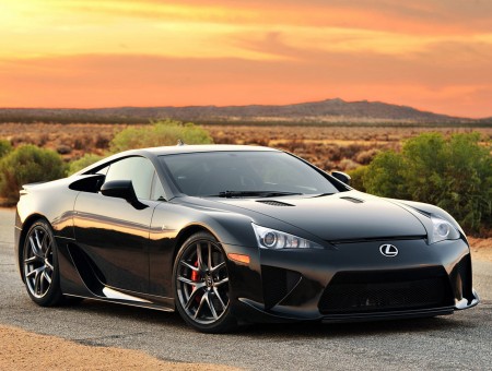 Black Lexus Coupe On Gray Rolled Asphalt Road During Sunset