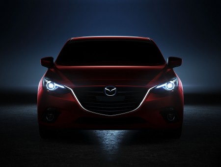 Red Mazda Car In The Dark With The Headlights On