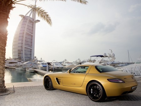 Yellow Luxury Car Beside Tree Near Yachts On Body Of Water During Daytime