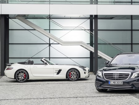 White Mercedes Convertible Beside Gray Luxury Car
