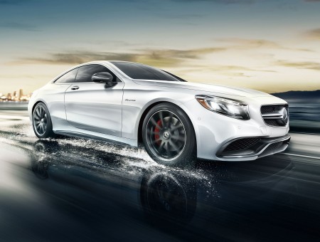 White Mercedes Benz AMG Coupe Running On Wet Road