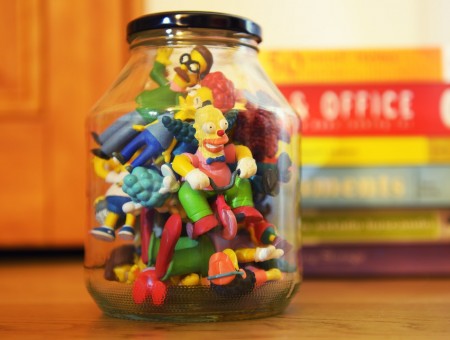 Clear Glass Jar Of Cartoon Character Figurines