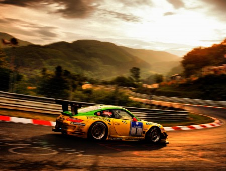 Time Lapse Photo Of Yellow Sports Car Travelling On Racetrack During Orange Sunset