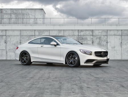 White Mercedes Benz Coupe Parked Beside Grey Concrete Wall