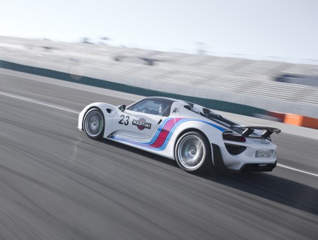 Time Lapse Photo Of White Red And Blue Number 23 Racing Car Travelling On Racetrack At Daytime