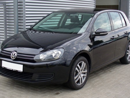 Black Volkswagen Polo By A Large Building On A Sunny Day
