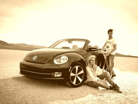 Man And Woman Leaning Against Black Volkswagen Beetle Convertible