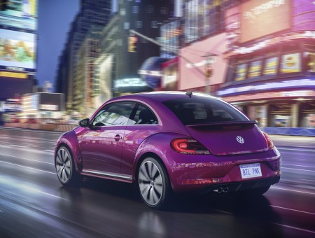 Purple Volkswagen New Beetle Running On Road During Nighttime