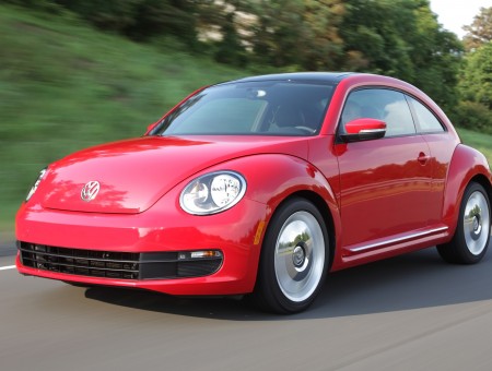 Red Volkswagen New Beetle Running On Road During Daytime