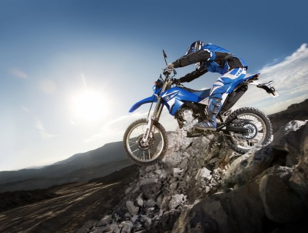 Motocross Rider In Blue On A Jump