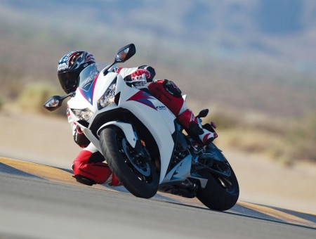 White And Red Racing Motorcycle In The Racing Track During Day Time