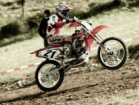 Man In White And Red Motorcycle Suit Riding Dirt Bike