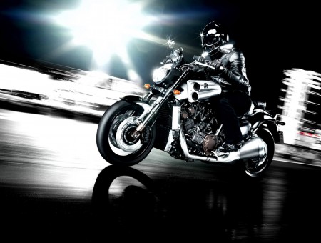 Man In Black Ridding Black And Chrome Cruise Motorcycle In Street