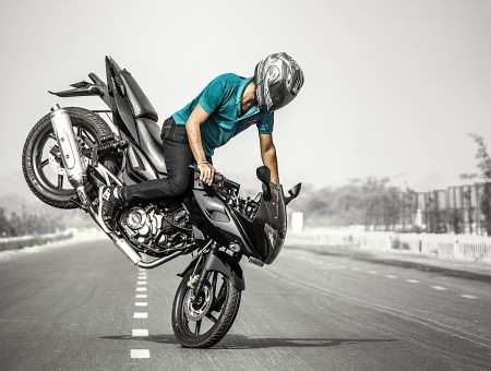 Man Driving Grey And Black Motorcycle Doing Stunts