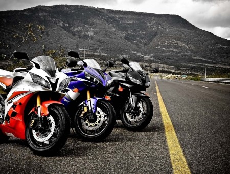 Blue White And Black Yamaha R1 Between 2 Black And Red Yamaha R1 Sport Bikes On Roadside During Daytime