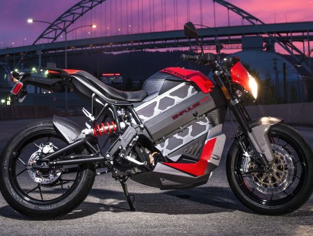 Red And Grey Sports Bike In Front Of Black Bridge During Sunset