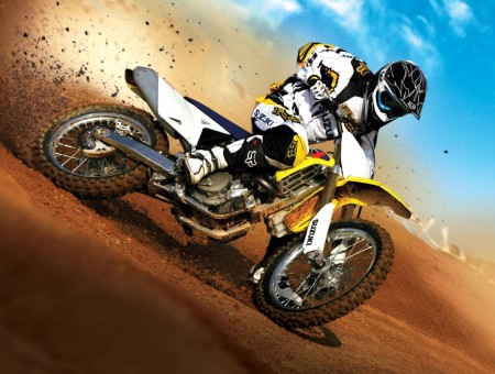 Man Wearing Black And White Off Road Helmet Riding Yellow And White Off Road Bike On The Field During Daytime