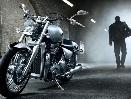 Grey Motorcycle Parked Near Man In Black Suit
