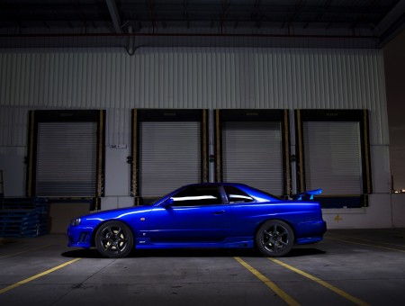 Blue Nissan Skyline Gtr R33 Parked By The Warehouse During Nighttime