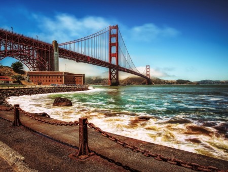 Golden Gate Bridge Over Wavy Sea Under Blue Sky During Daytime