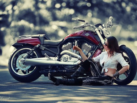 Woman In Black Pants Sitting Beside Red Motorcycle During Daytime
