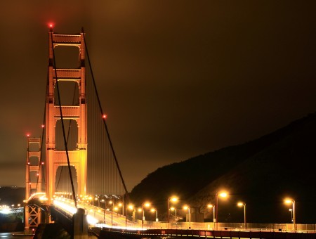 Lighted Street Lights On Gray Long Bridge During Nighttime