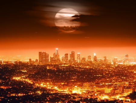 Lighted City Buildings Under Full Moon At Nighttime