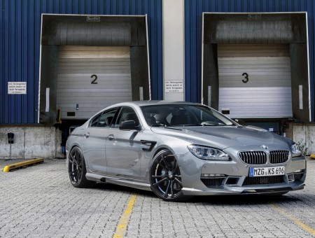 Silver BMW M6 Parked In Front Of Garage