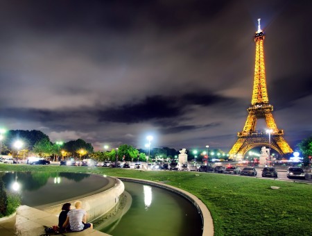 Cars On The Road Beside The Eiffel Tower Lighted At Night